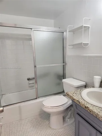 a white toilet sitting next to a bath tub