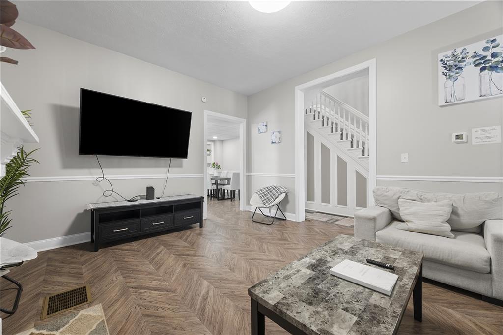 144 Bigham Street Pittsburgh, PA 15211 - Photo 11 of 45 a living room with furniture and a flat screen tv
