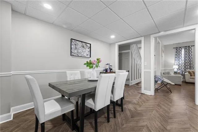 a kitchen with refrigerator cabinets dining table and chairs