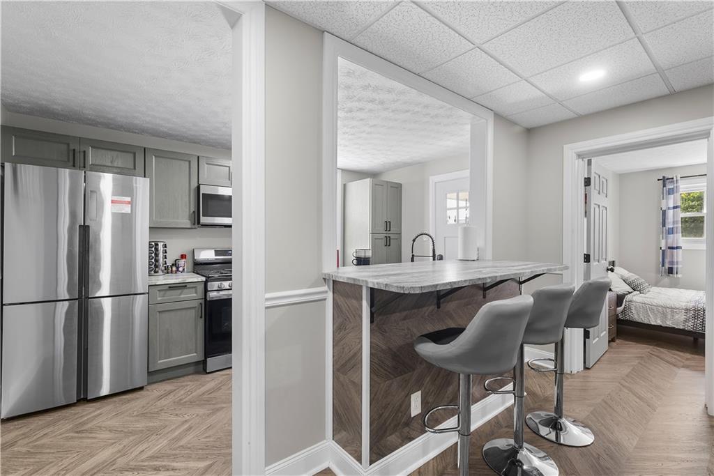 144 Bigham Street Pittsburgh, PA 15211 - Photo 16 of 45 a kitchen with refrigerator cabinets dining table and chairs