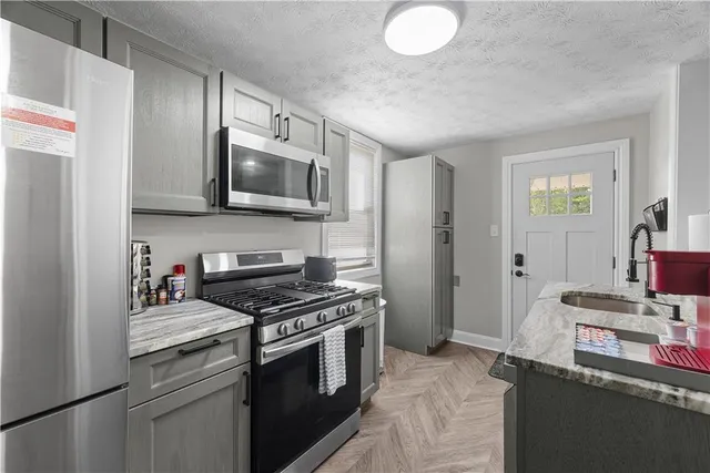 a kitchen with stainless steel appliances a stove a microwave and cabinets