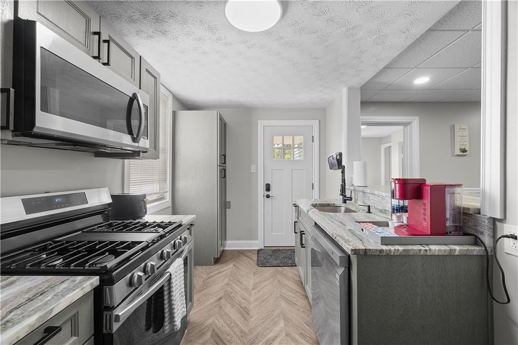 144 Bigham Street Pittsburgh, PA 15211 - Photo 19 of 45 a kitchen with a stove and a microwave
