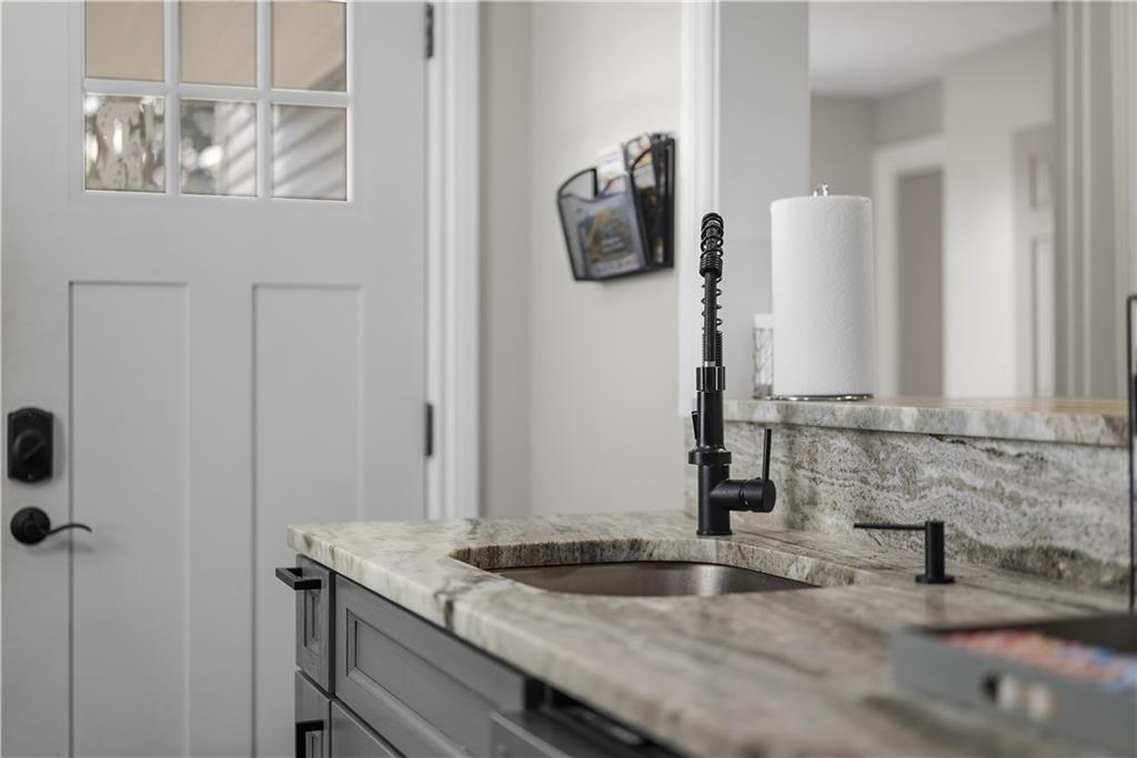 144 Bigham Street Pittsburgh, PA 15211 - Photo 20 of 45 a bathroom with a granite countertop sink and a mirror