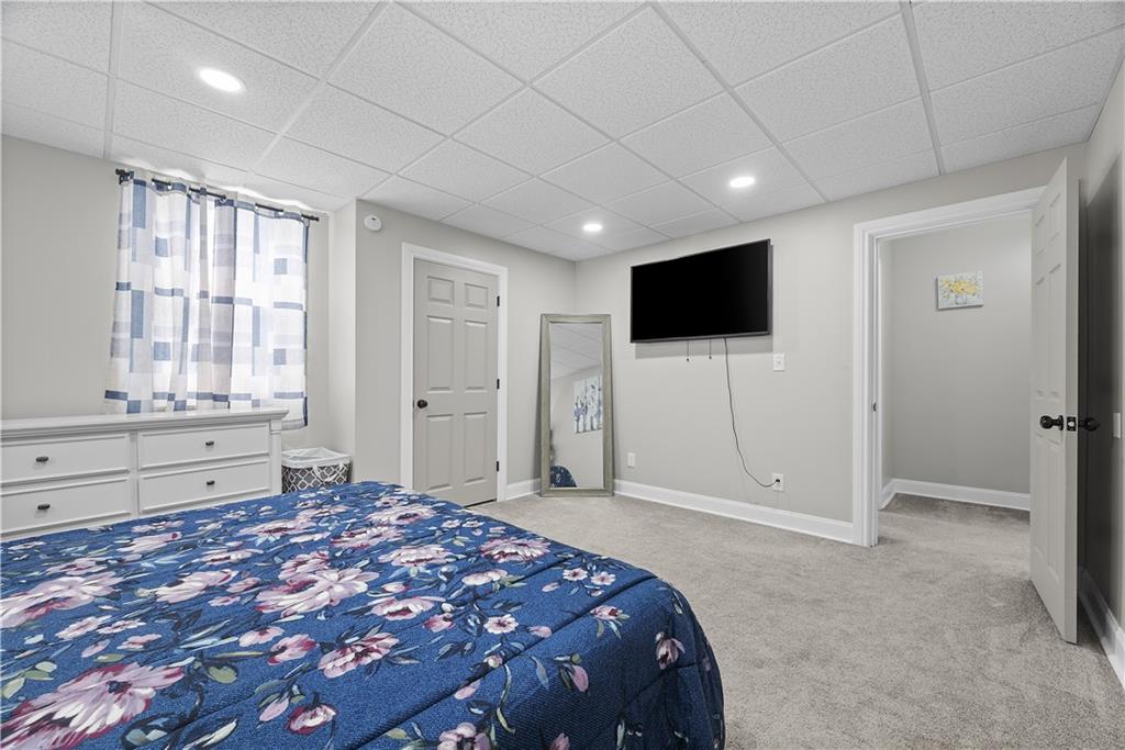 144 Bigham Street Pittsburgh, PA 15211 - Photo 29 of 45 a spacious bedroom with a bed and a flat screen tv