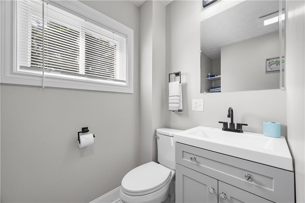 144 Bigham Street Pittsburgh, PA 15211 - Photo 31 of 45 a bathroom with a toilet a sink a mirror and a window