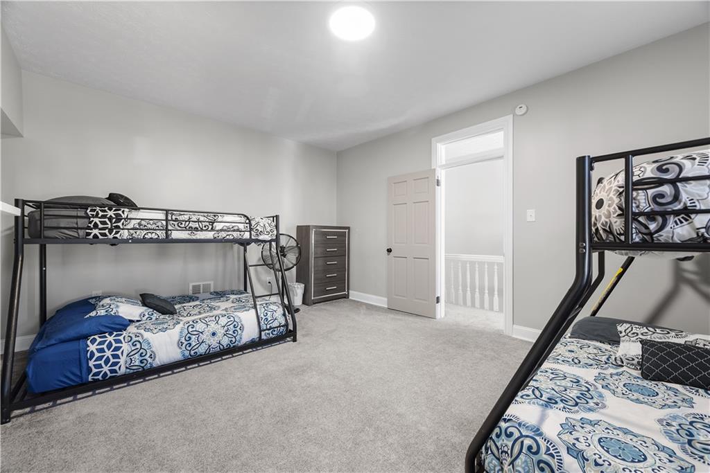 144 Bigham Street Pittsburgh, PA 15211 - Photo 34 of 45 a bedroom with furniture and a chandelier