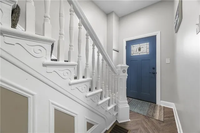 a view of entryway and hall with a front door