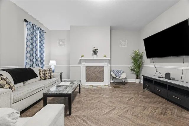 a living room with furniture and a flat screen tv