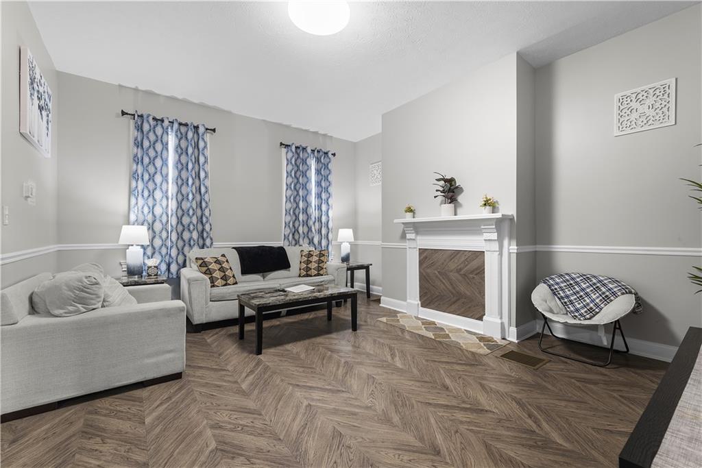 144 Bigham Street Pittsburgh, PA 15211 - Photo 8 of 45 a living room with furniture and a fireplace