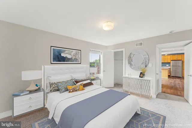 a bedroom with a bed a window and dresser