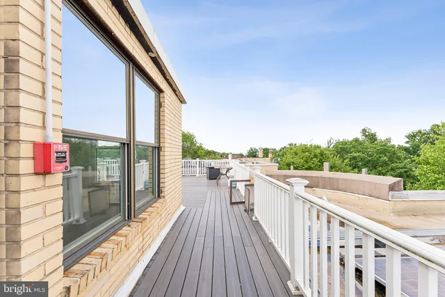 a view of a chair and table on the roof deck