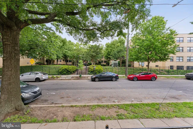 a view of cars parked in front of a house