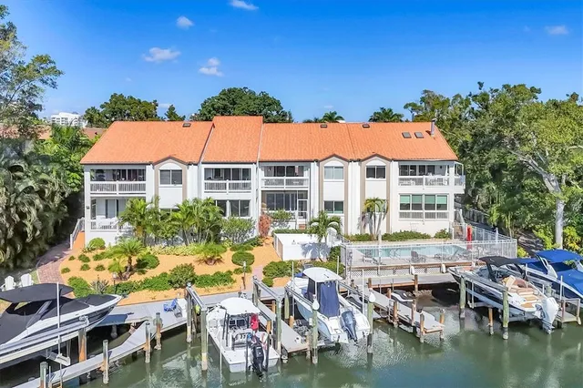 a view of house with swimming pool and outdoor seating