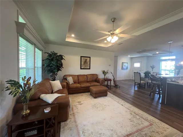 a living room with furniture potted plant and a window