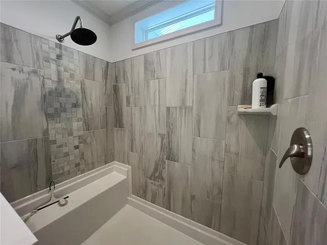 a bathroom with a shower and a tub