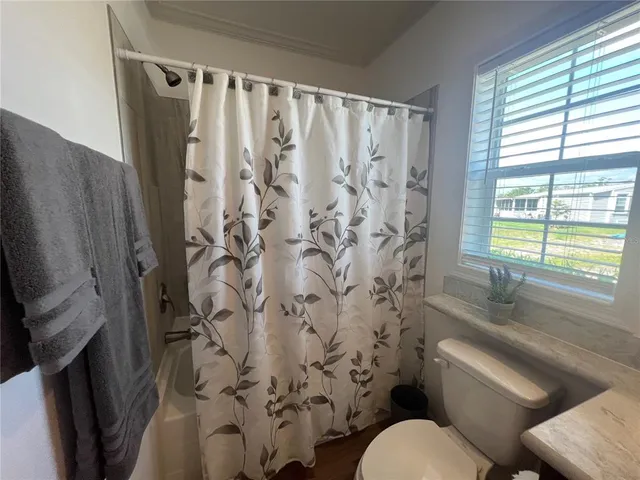 a bathroom with a toilet a sink and a shower