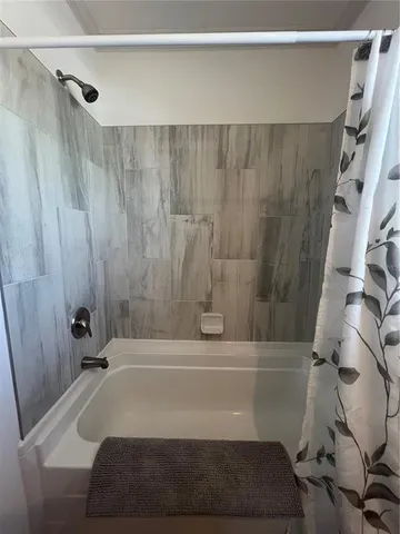 a bathroom with a tub and a shower