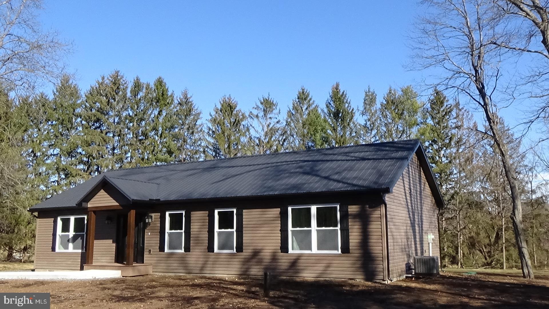 130 Soule Road New Bloomfield, PA 17068 - Photo 2 of 23 a front view of a house with a yard and trees
