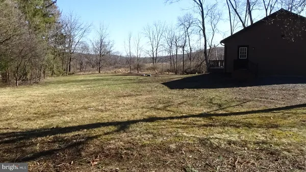 a view of a yard with wooden fence