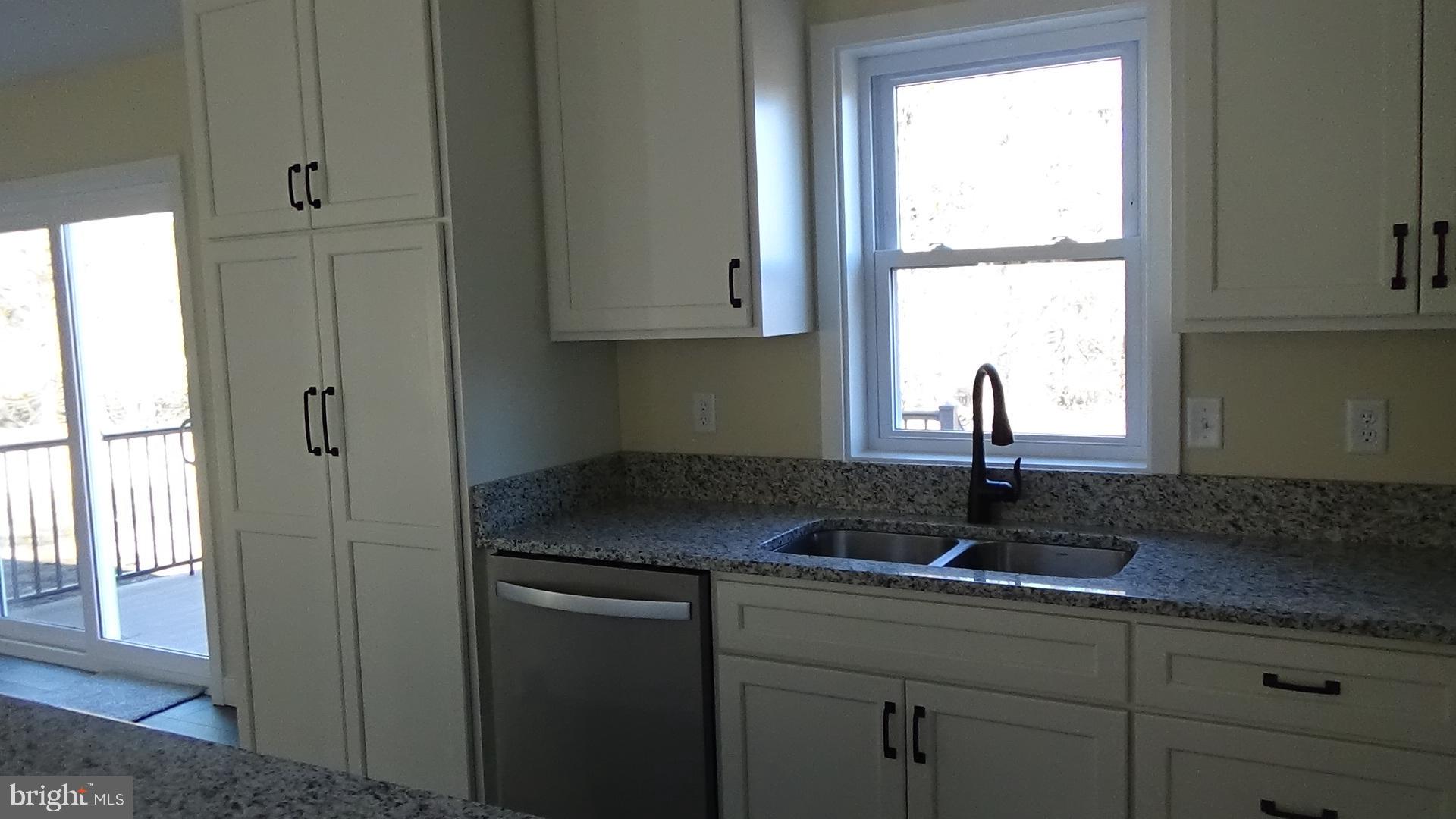 130 Soule Road New Bloomfield, PA 17068 - Photo 5 of 23 a kitchen with granite countertop white cabinets and window