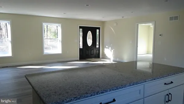 a view of a livingroom with wooden floor and window