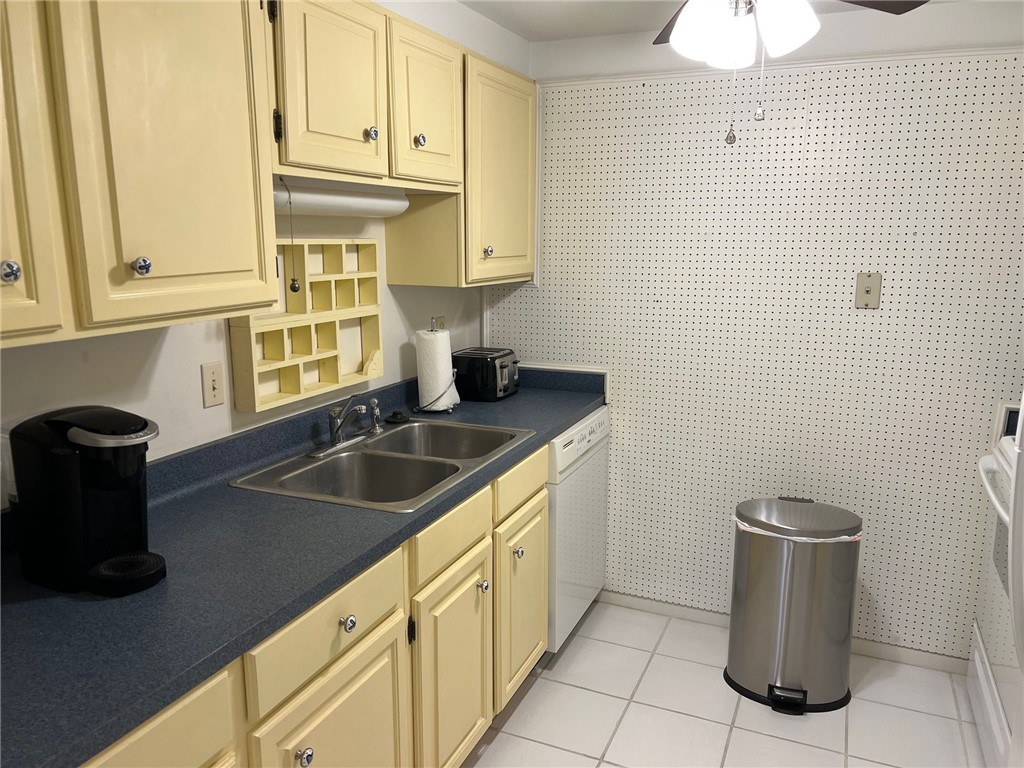 520 South Chaparral Street, Unit 204 Corpus Christi, TX 78401 - Photo 5 of 24 a kitchen with a sink and cabinets