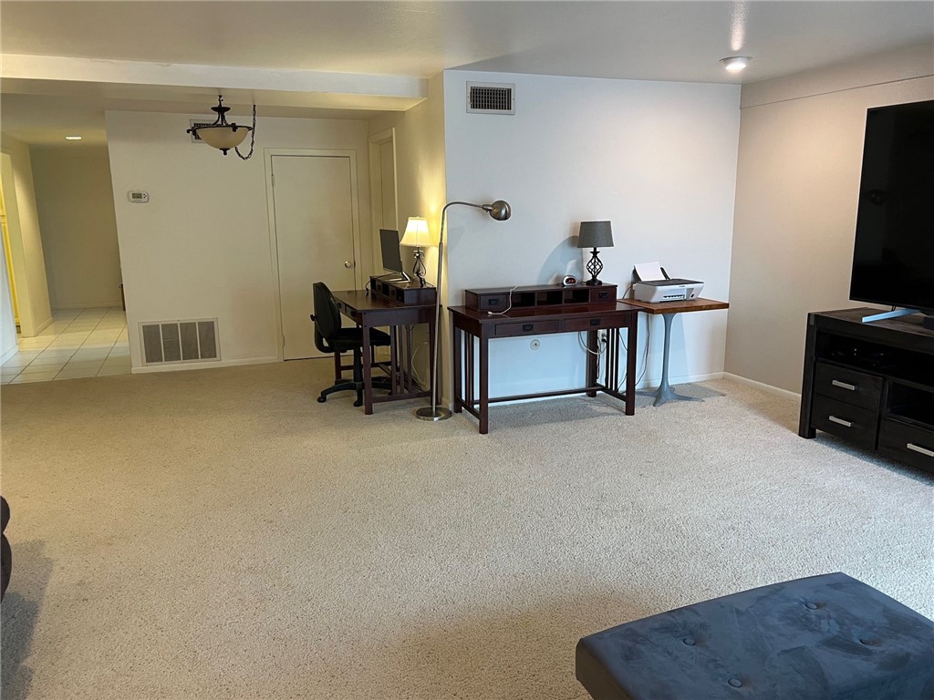 520 South Chaparral Street, Unit 204 Corpus Christi, TX 78401 - Photo 10 of 24 a living room with furniture and a flat screen tv