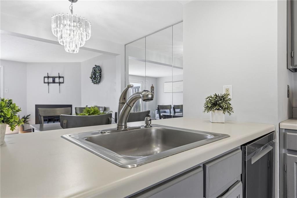 307 Hamlet Court Pittsburgh, PA 15227 - Photo 14 of 43 a kitchen with a sink a counter and a chandelier