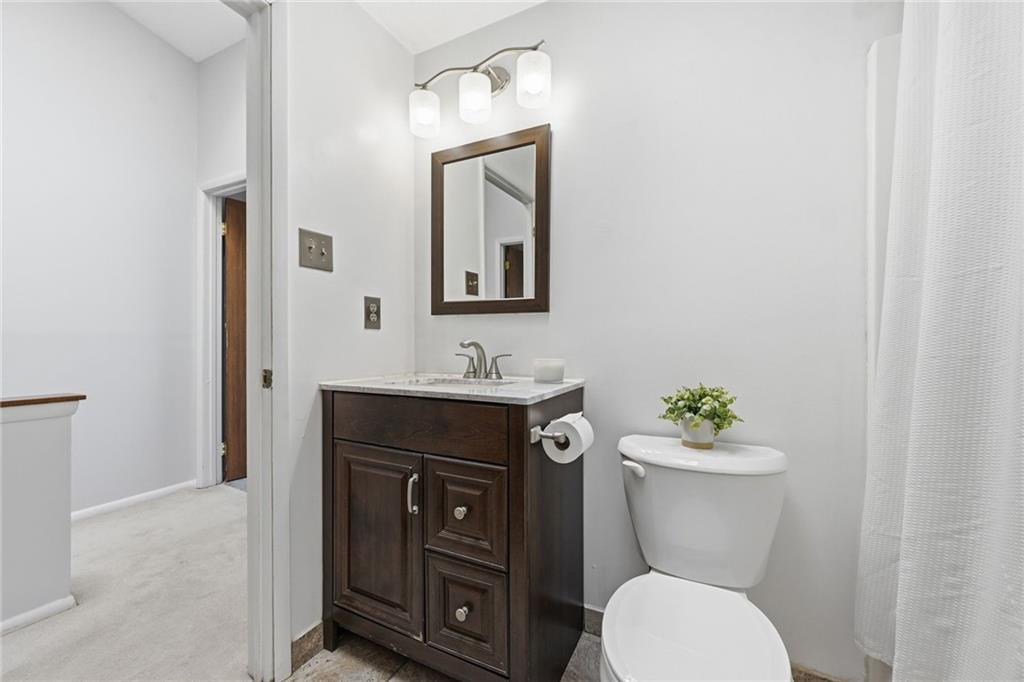 307 Hamlet Court Pittsburgh, PA 15227 - Photo 24 of 43 a bathroom with a toilet sink vanity and mirror