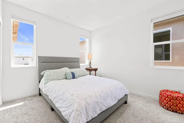 a bedroom with a bed and a ceiling fan