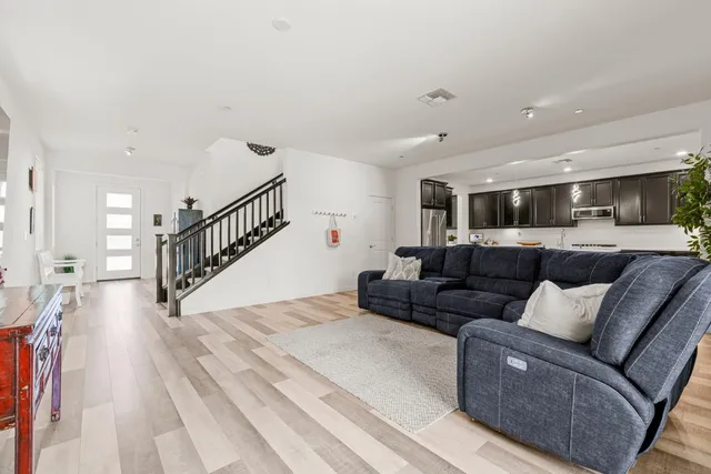 a kitchen with kitchen island granite countertop stainless steel appliances and sink