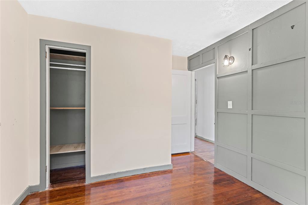 11680 Aaron Road Jacksonville, FL 32218 - Photo 13 of 26 a view of an empty room with wooden floor and closet