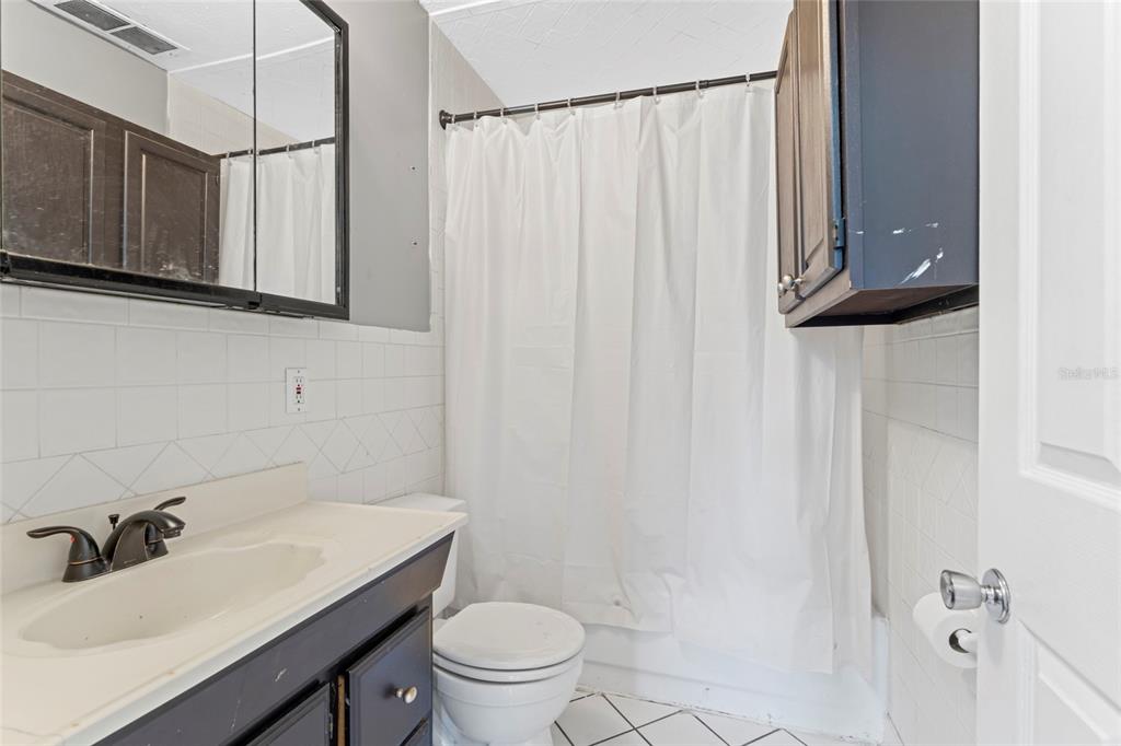 11680 Aaron Road Jacksonville, FL 32218 - Photo 14 of 26 a bathroom with a sink toilet and shower