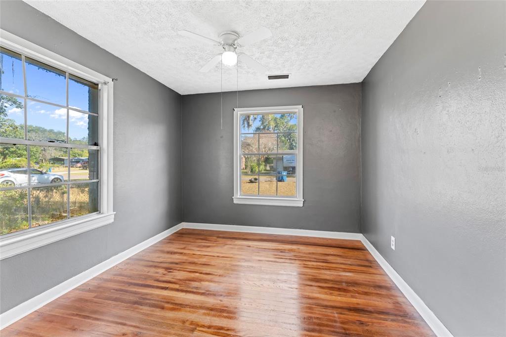 11680 Aaron Road Jacksonville, FL 32218 - Photo 15 of 26 a view of an empty room with wooden floor and a window