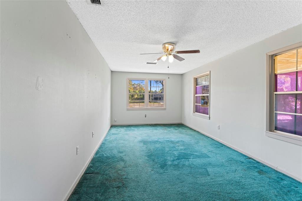 11680 Aaron Road Jacksonville, FL 32218 - Photo 19 of 26 an empty room with windows and ceiling fan