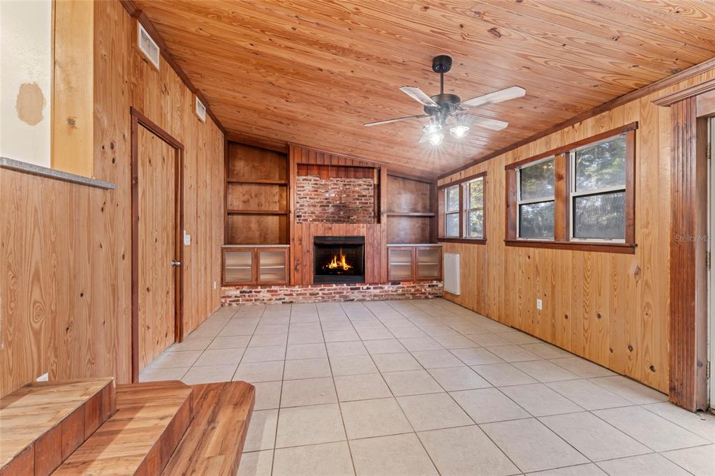 11680 Aaron Road Jacksonville, FL 32218 - Photo 10 of 26 a view of an empty room with a fireplace and a window