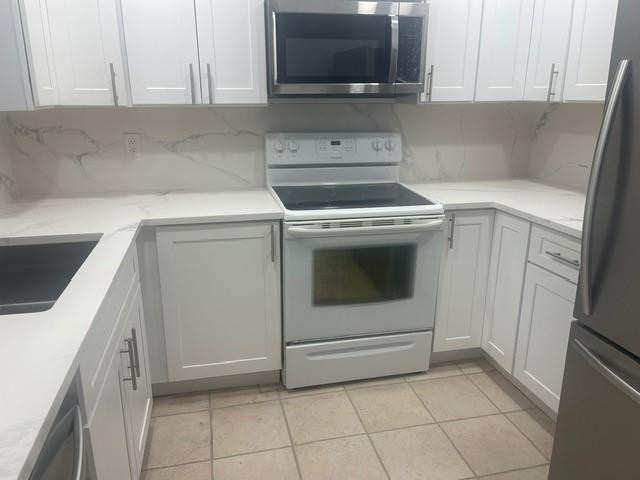 301 North Pine Island Road, Unit 110 Plantation, FL 33324 - Photo 4 of 13 a utility room with sink dryer and washer
