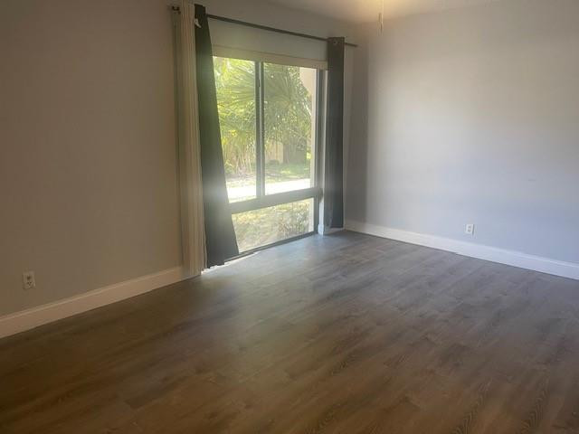 301 North Pine Island Road, Unit 110 Plantation, FL 33324 - Photo 7 of 13 an empty room with wooden floor and windows