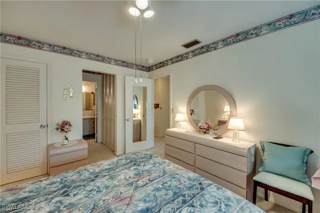 a living room with a bed furniture and a chandelier