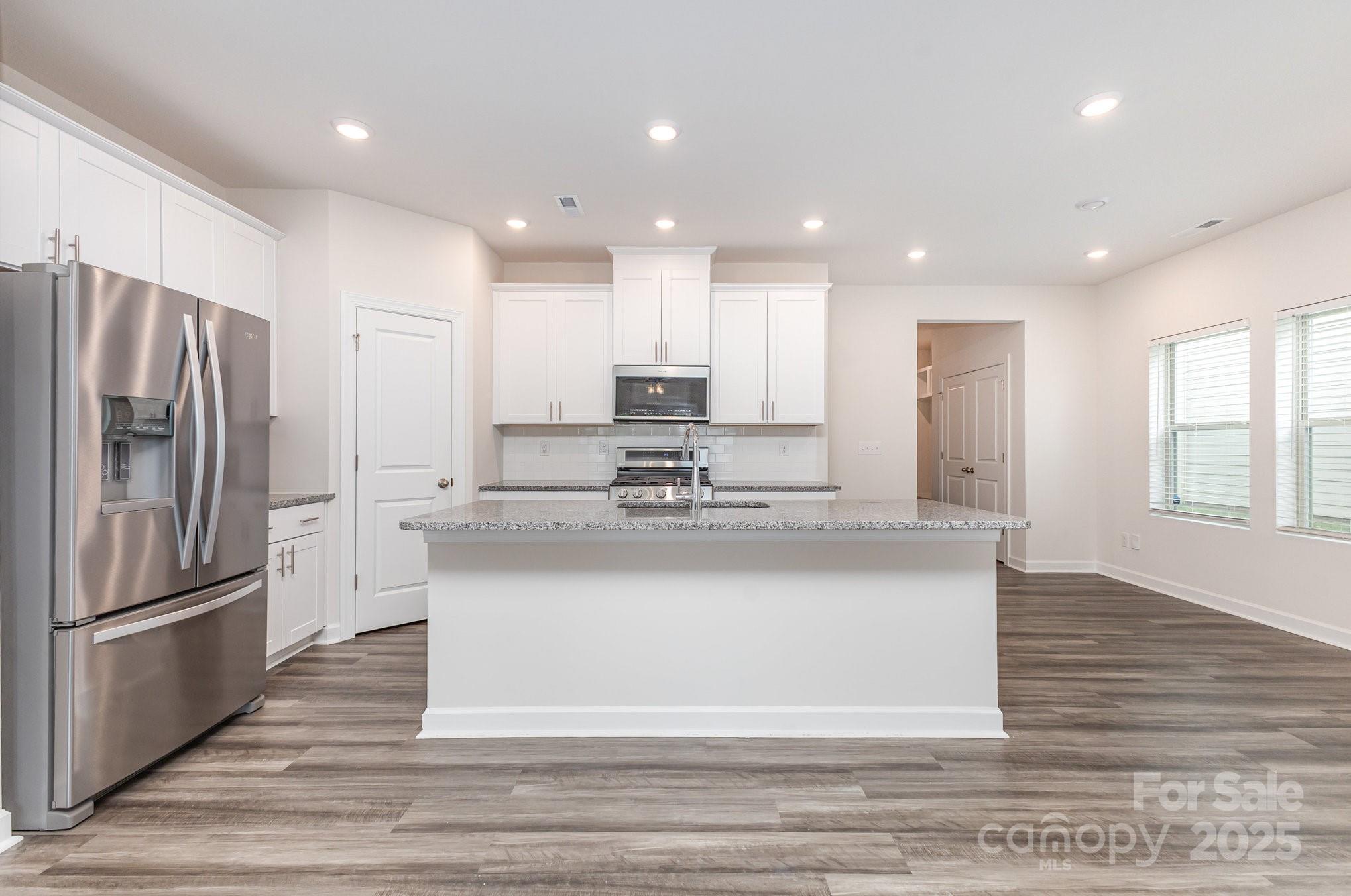 4003 Armstrong Farm Drive Belmont, NC 28012 - Photo 13 of 32 a view of kitchen with stainless steel appliances granite countertop cabinets and wooden floor
