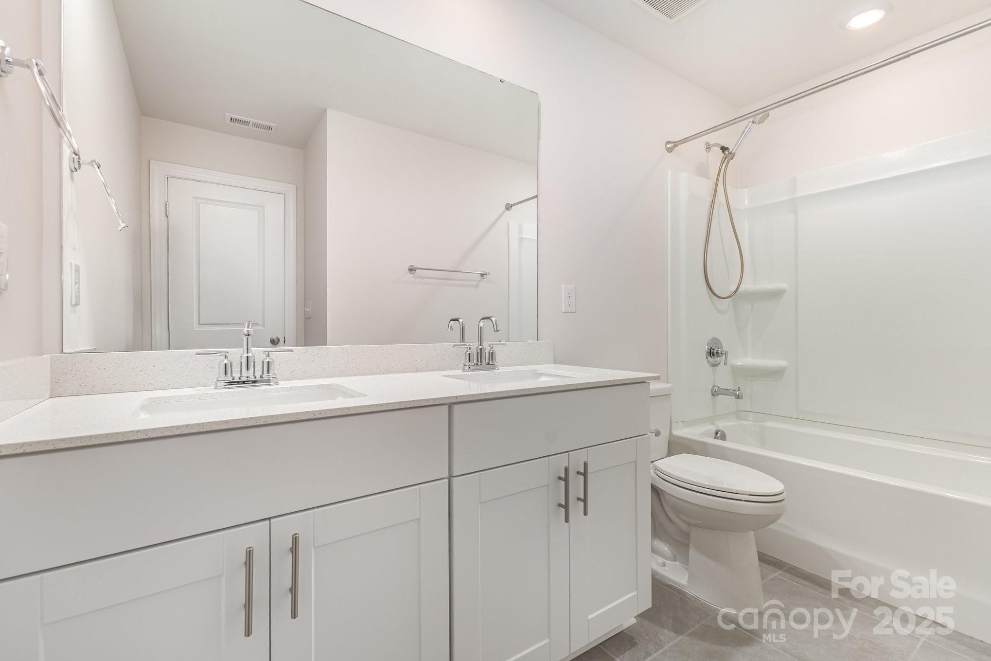 4003 Armstrong Farm Drive Belmont, NC 28012 - Photo 20 of 32 a bathroom with a granite countertop sink a toilet and a bathtub
