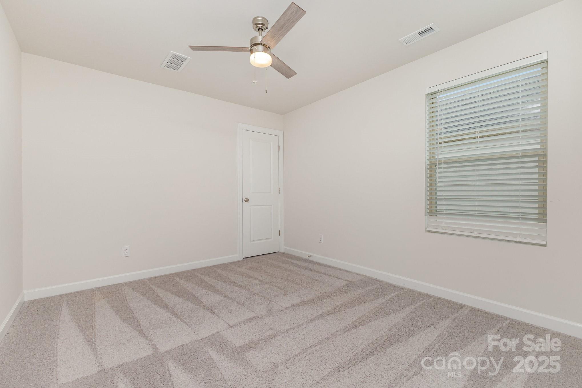 4003 Armstrong Farm Drive Belmont, NC 28012 - Photo 23 of 32 a view of a room with a ceiling fan and a window