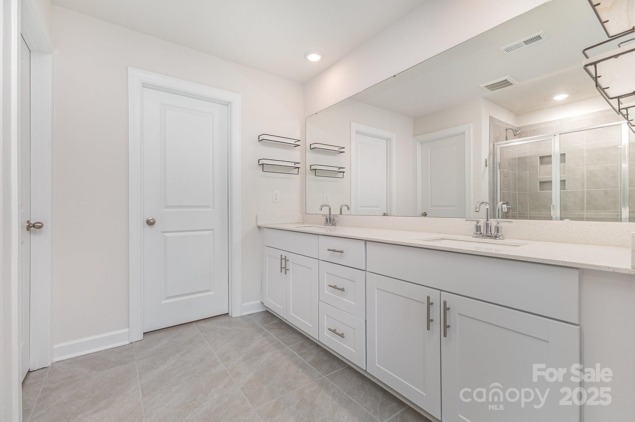 4003 Armstrong Farm Drive Belmont, NC 28012 - Photo 26 of 32 a bathroom with double sink and a mirror