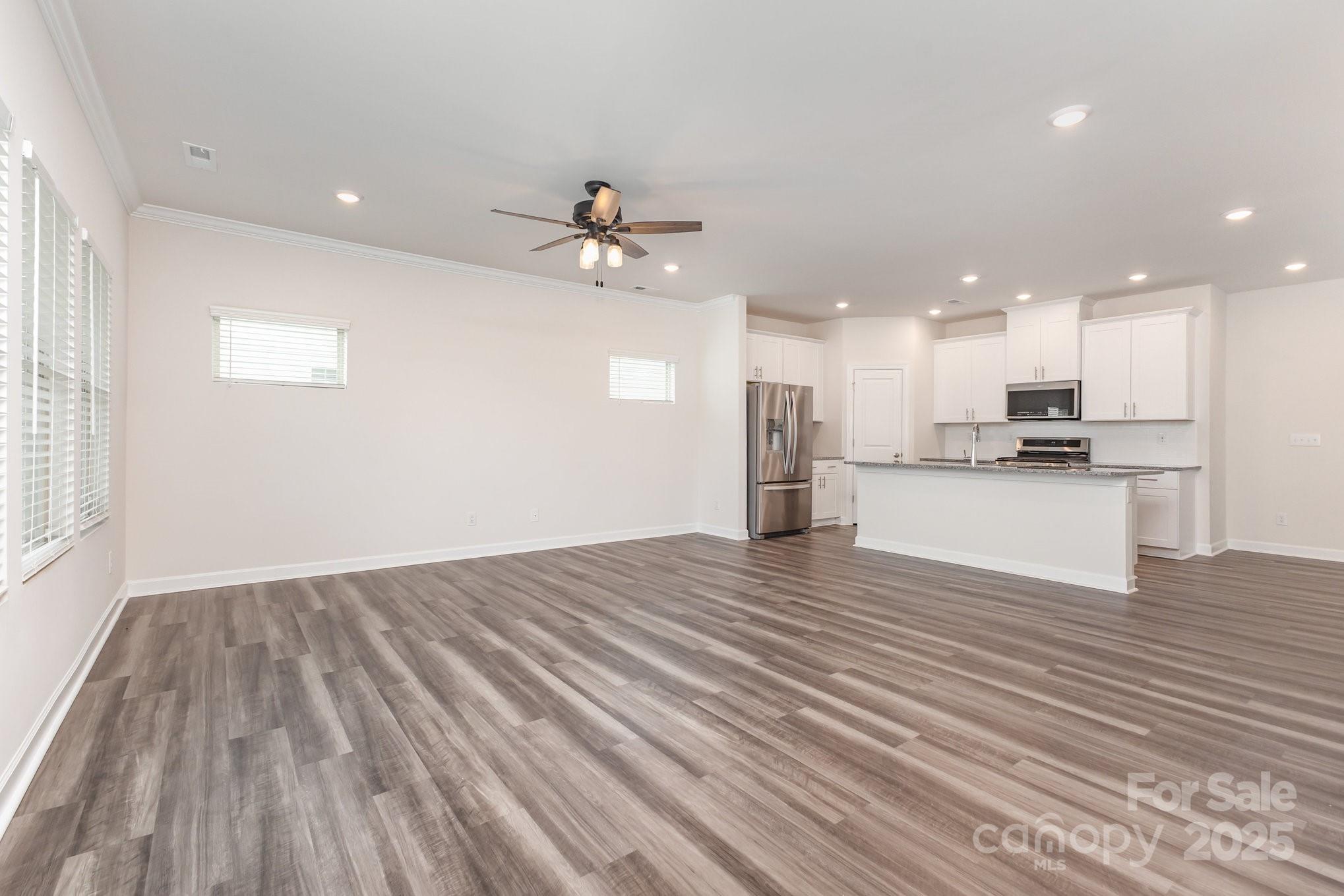 4003 Armstrong Farm Drive Belmont, NC 28012 - Photo 6 of 32 a view of kitchen with wooden floor and a kitchen island