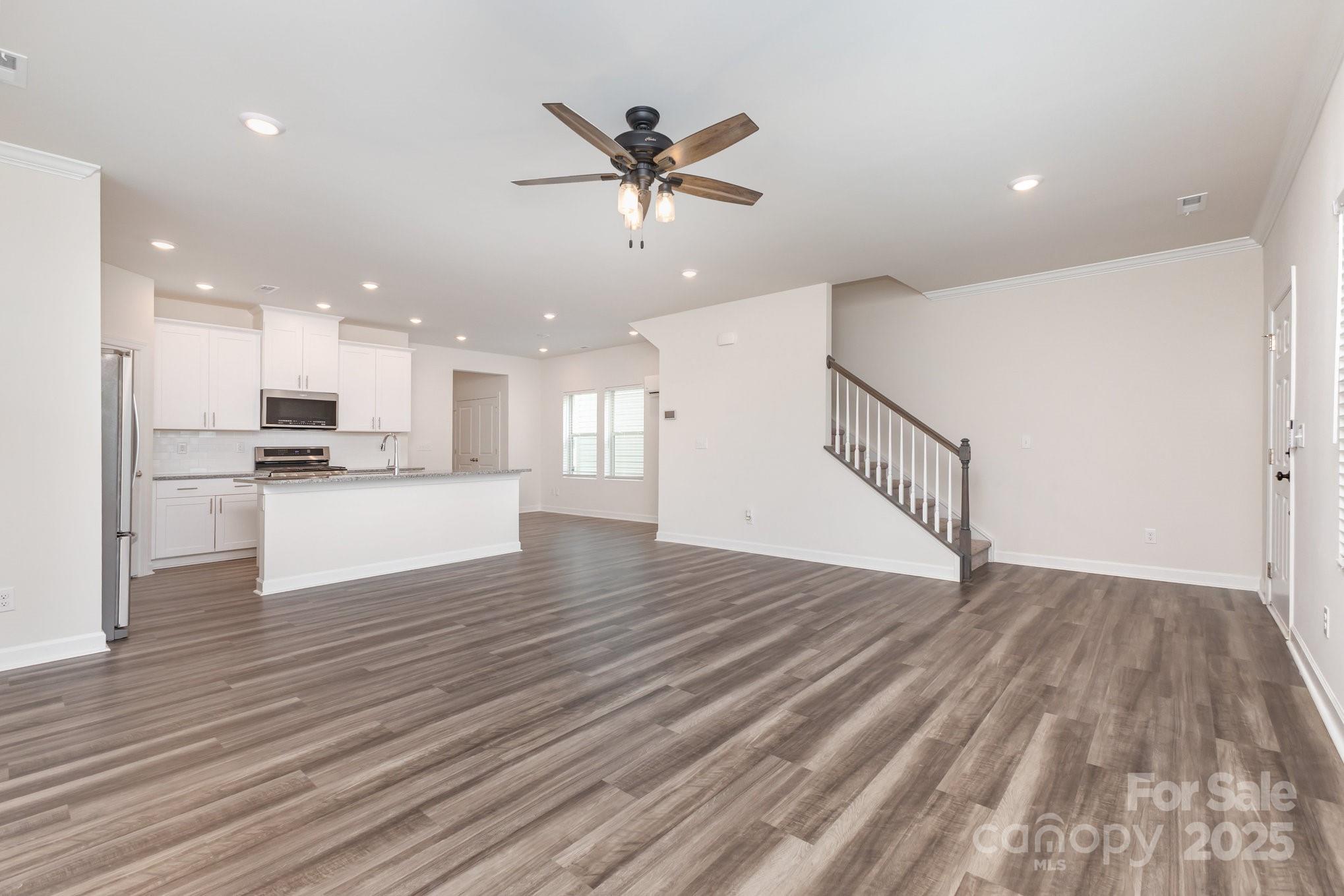 4003 Armstrong Farm Drive Belmont, NC 28012 - Photo 7 of 32 a view of kitchen with cabinets wooden floor and a ceiling fan