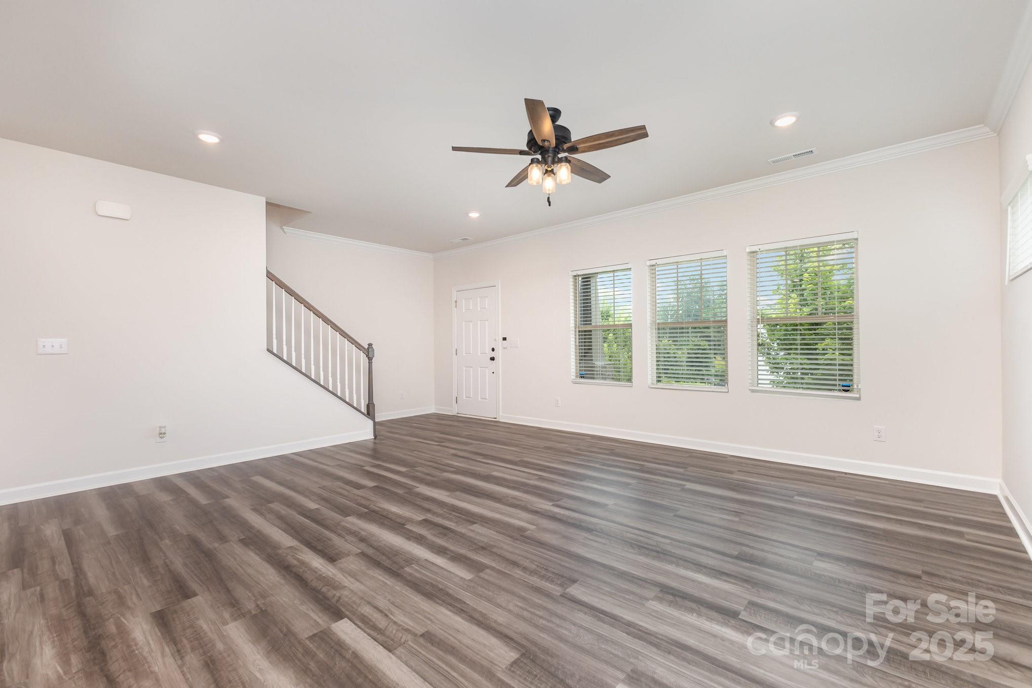 4003 Armstrong Farm Drive Belmont, NC 28012 - Photo 8 of 32 a view of empty room with wooden floor and fan