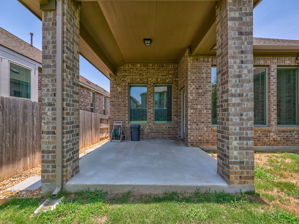 229 Heartleaf Road San Marcos, TX 78666 - Photo 6 of 40 An inviting covered patio extends outdoor living space, perfect for relaxing afternoons.