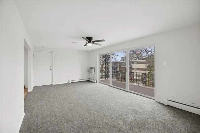 a view of a livingroom with a ceiling fan and window