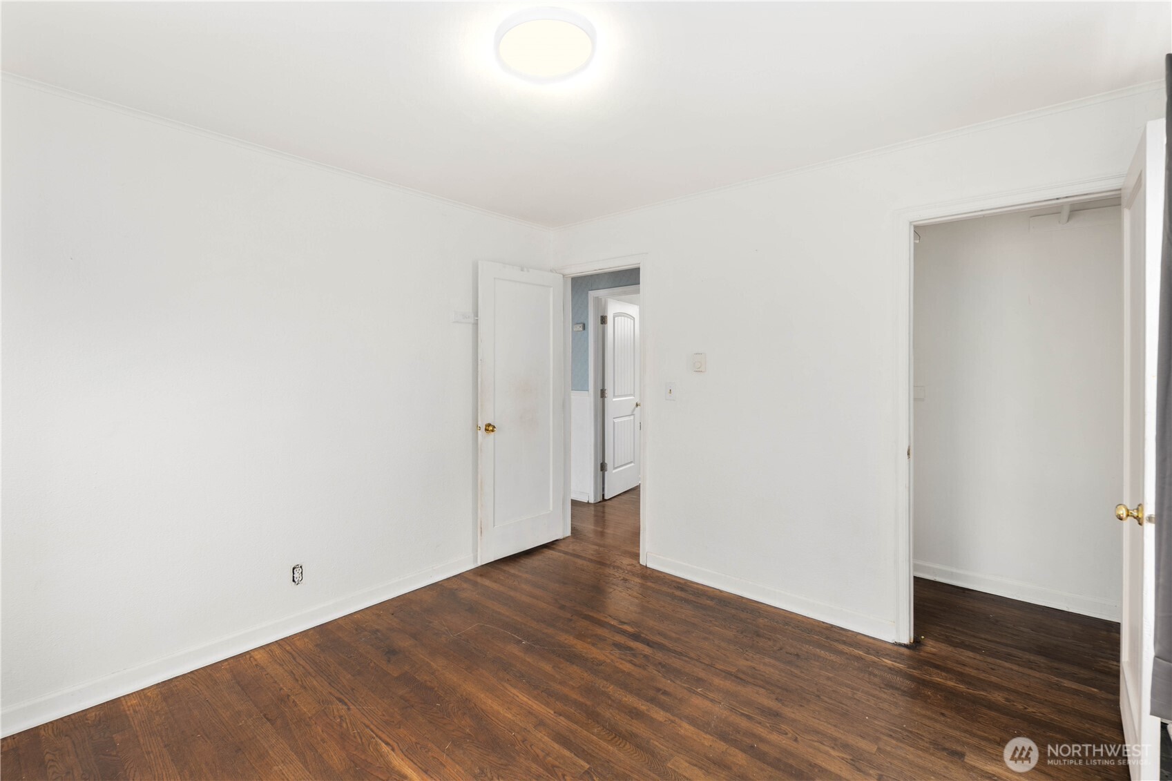 1218 South Ridgewood Avenue Tacoma, WA 98405 - Photo 12 of 24 a view of an empty room with wooden floor