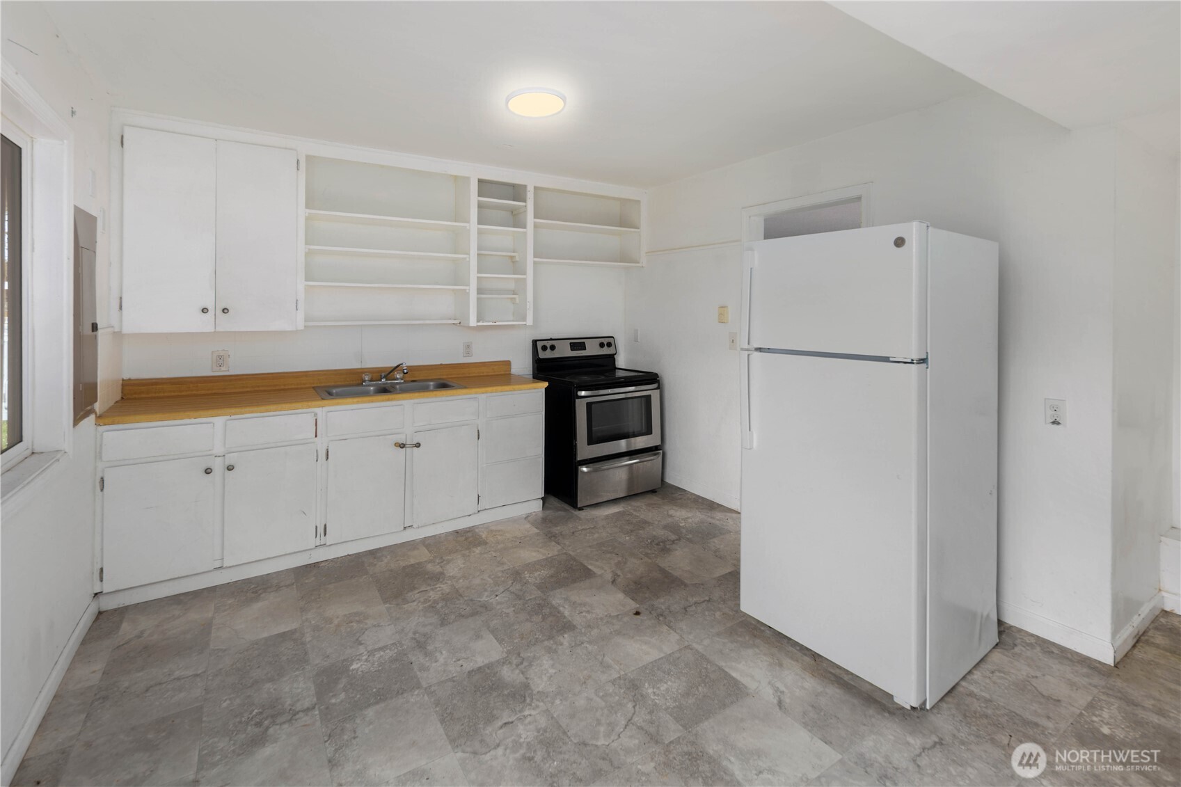1218 South Ridgewood Avenue Tacoma, WA 98405 - Photo 13 of 24 a kitchen with white cabinets and white appliances